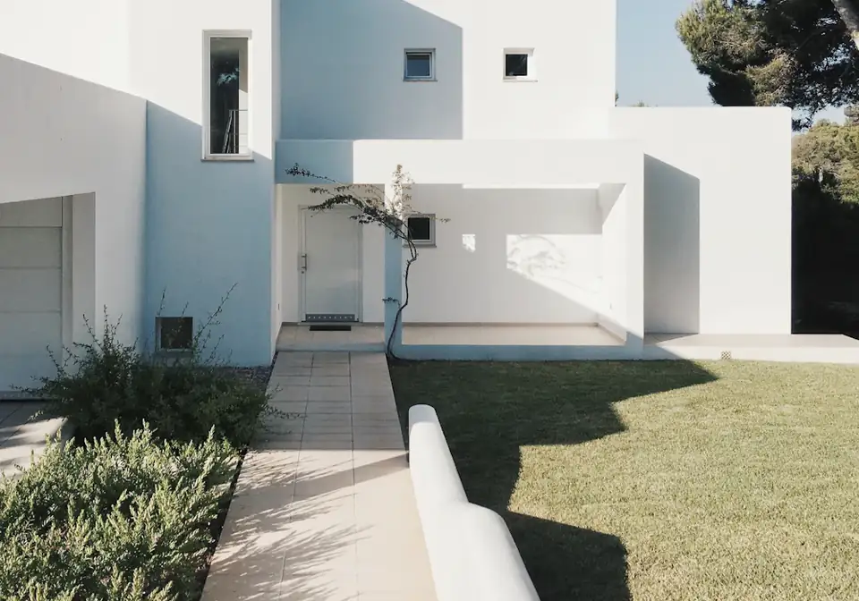 Modern white home with a lawn